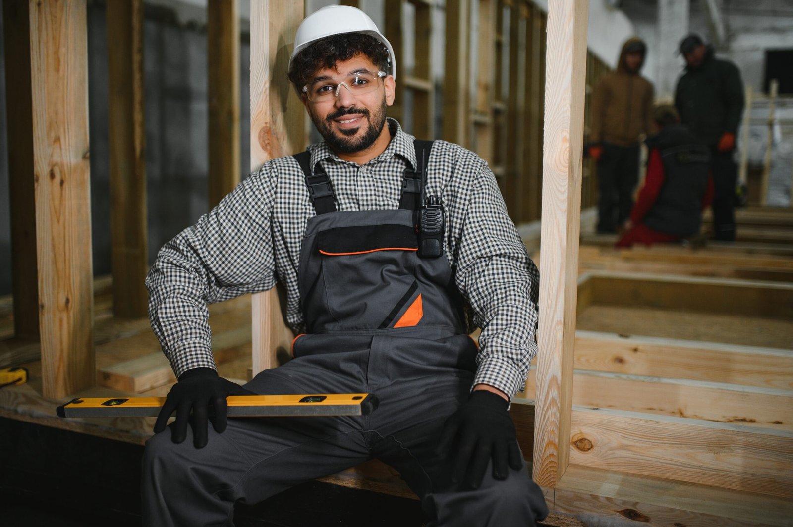 Arab kitchen remodeling worker sitting and smiling in modular house production workshop